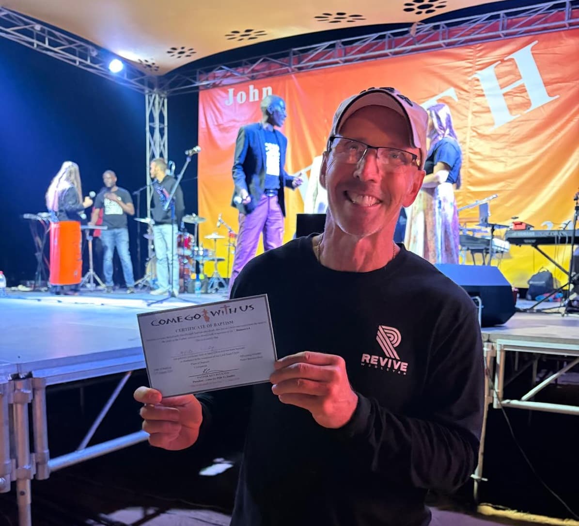 David Luby holding his Certificate of Baptism